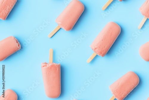 Obraz na płótnie Pink ice cream stick treats arranged on a vibrant blue background w salonie