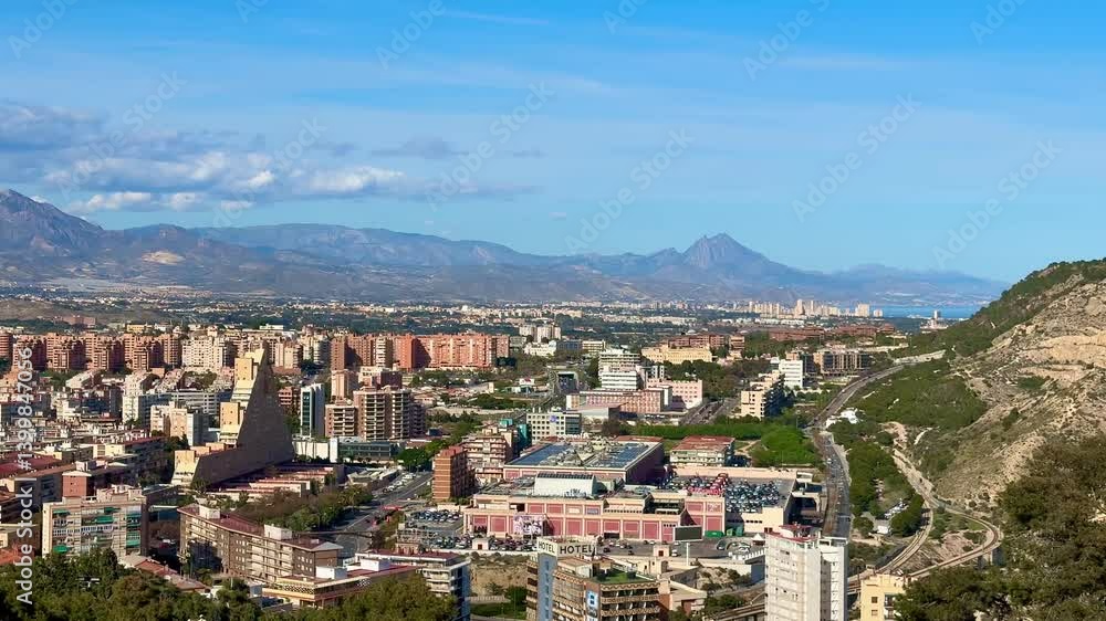 Enjoy a stunning panoramic view of the urban landscape, majestic mountains, and clear blue skies above Enjoy a stunning panoramic view of the urban landscape, majestic mountains, and clear blue skies above