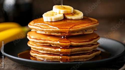 Wallpaper Mural A stack of homemade oat pancakes with maple syrup, topped with banana slices, Torontodigital.ca
