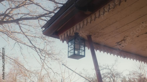 Wallpaper Mural Old Lantern Hangs Under Fading Eaves on a Cold Estonian Morning Torontodigital.ca