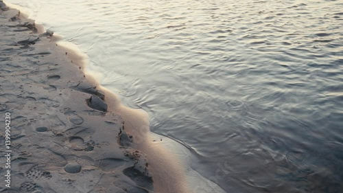 Wallpaper Mural Worn Footprints and Crumbling Sand Edge Beside Quiet Flowing Waters Torontodigital.ca