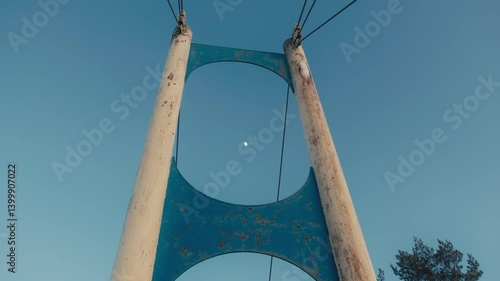 Wallpaper Mural Bridge Structure Framing the Moon Against Blue Sky Torontodigital.ca