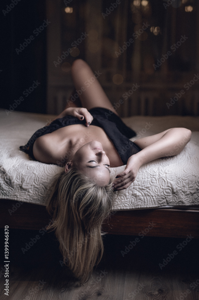 Obraz premium Young sexy woman lying on the bed