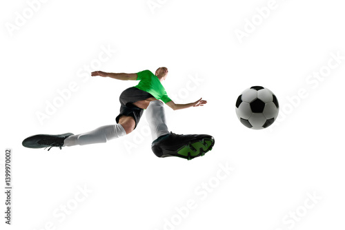Obraz na płótnie Low angle of football striker, dressed black and green sport uniform, shooting goal with full force in motion against white studio background. Concept of professional sport, training, tournament. Ad w salonie