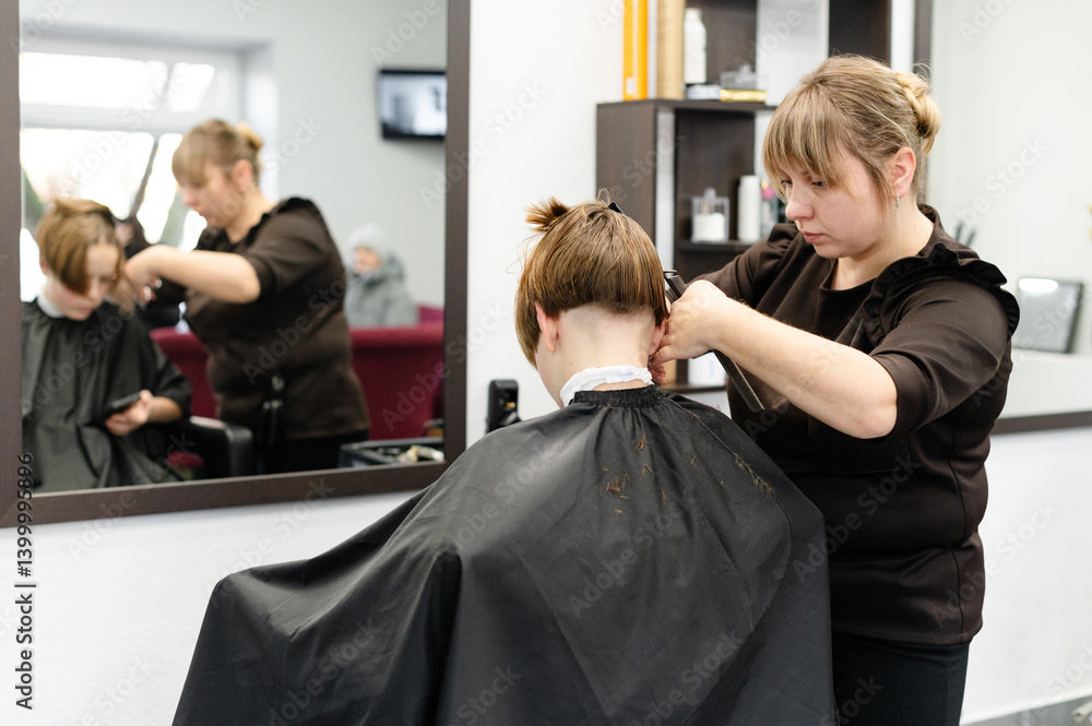 Stylish haircut being done in a modern salon with a focused stylist and client in comfortable setting Stylish haircut being done in a modern salon with a focused stylist and client in comfortable setting