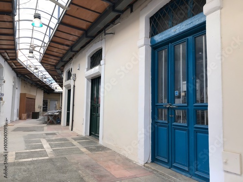Quiet arcade with blue door and arched roof in vintage building
