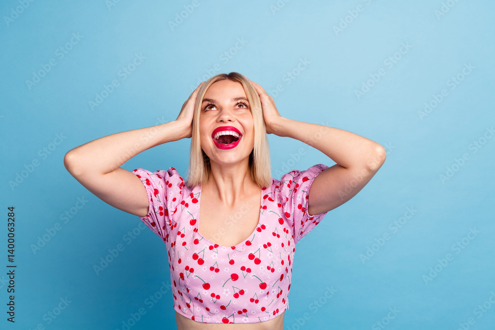 Photo of cheerful glad lovely girl wear trendy pink print clothes look empty space offer isolated on blue color background Photo of cheerful glad lovely girl wear trendy pink print clothes look empty space offer isolated on blue color background