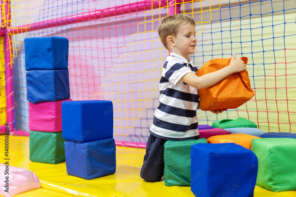 Boy playing with soft foam blocks