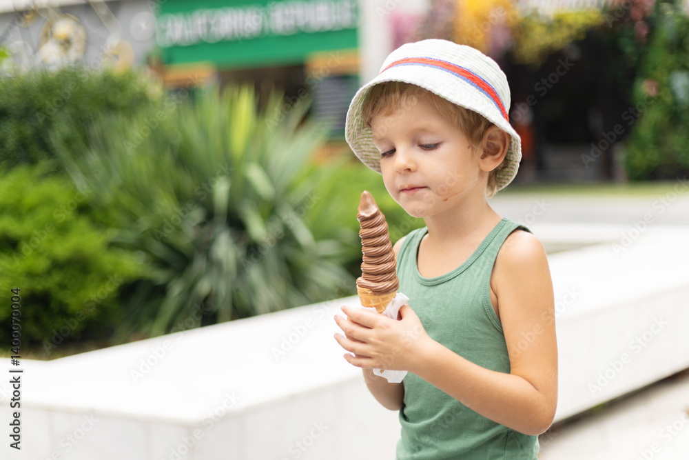 Child eating chocolate ice cream cone outdoors