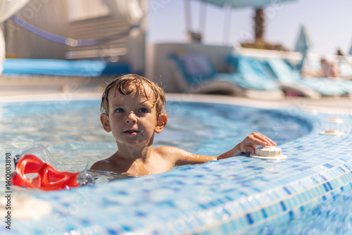 Boy relaxing in swimming pool outdoors