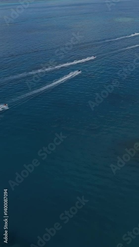 Wallpaper Mural Aerial view of group of water scooters in transparent water of Indian Ocean at sunny day. High speed shooting.Vertical video  Torontodigital.ca