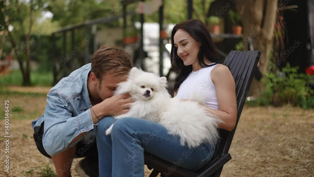 A joyful couple enjoys playful moments alongside their adorable Pomeranian in a beautiful, serene outdoor setting A joyful couple enjoys playful moments alongside their adorable Pomeranian in a beautiful, serene outdoor setting