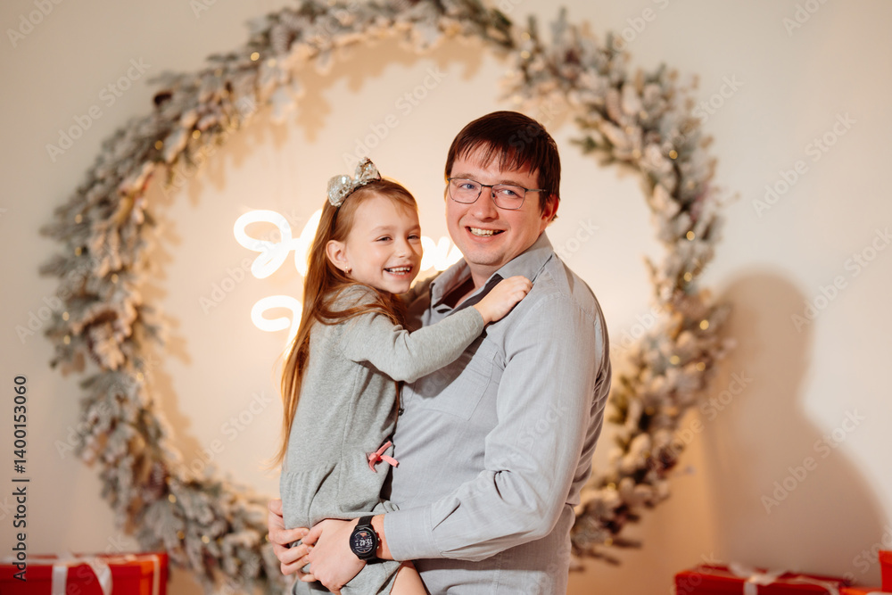 Happy dad and daughter in christmas decor.