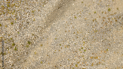 Obraz na płótnie Aerial view perpendicular to rugged terrain with pebbles. ideal for texture, pattern and background w salonie