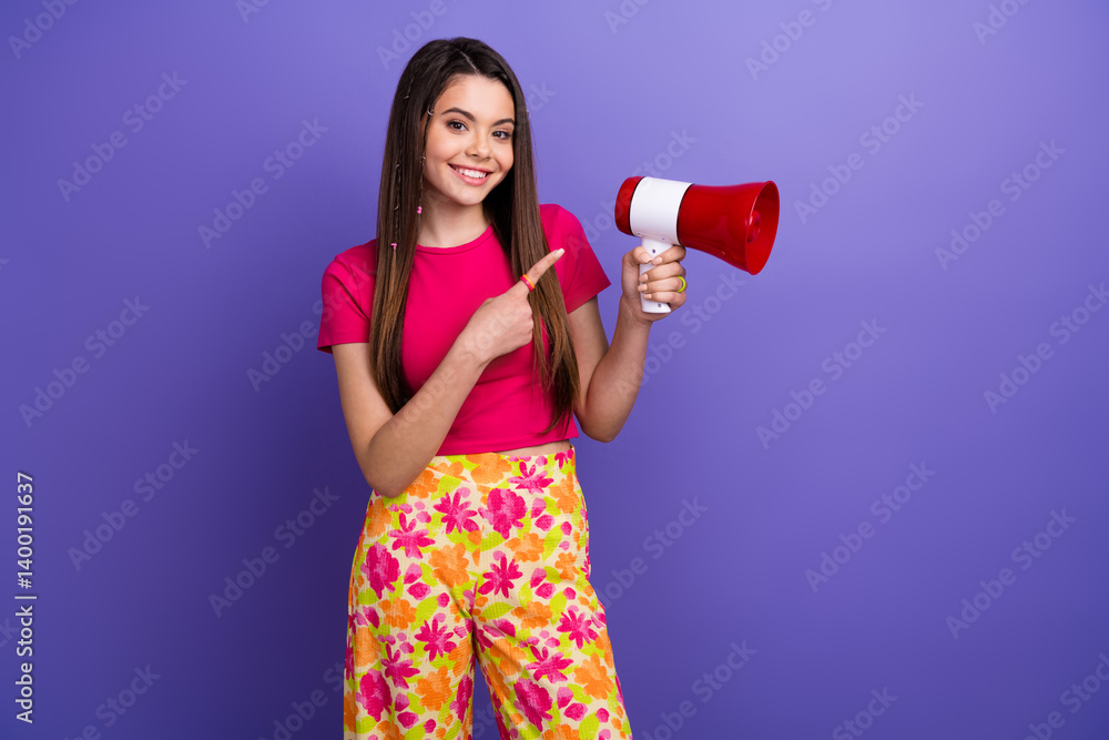 Smiling young woman in bright fashion holding a megaphone, standing against a vibrant pink and purple background Smiling young woman in bright fashion holding a megaphone, standing against a vibrant pink and purple background