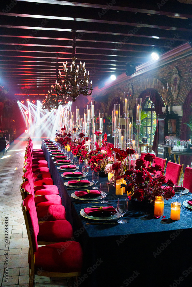Spotlights in the banquet hall of a dark restaurant.