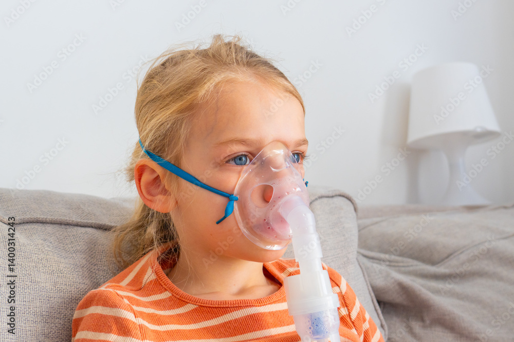 Young girl receives respiratory treatment at home while sitting comfortably on a couch during a sunny afternoon