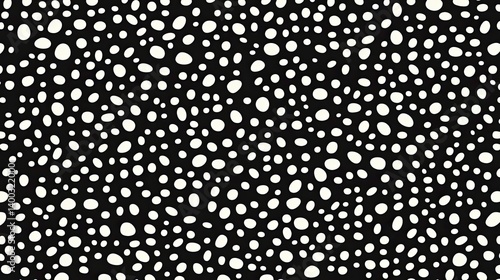 Seamless monochrome pattern featuring dispersed organic white shapes on black