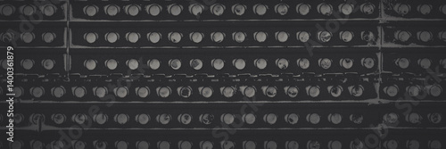 Obraz na płótnie Metal texture with perforation. Snowy rusty metal fence with holes. Faded dark wide panoramic background for design. w salonie
