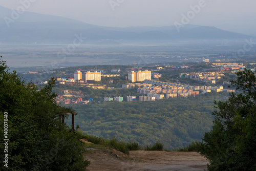 Obraz na płótnie Morning cityscape. View from the mountain to residential buildings. City block in the forest on a hill. Mountains in the distance. City of Petropavlovsk-Kamchatsky, Kamchatka Krai, Far East of Russia. w salonie