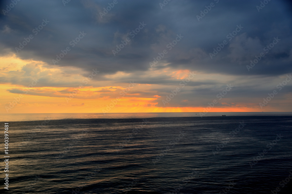 Fototapeta premium Bird's eye view of the sea at sunset before a thunderstorm.
