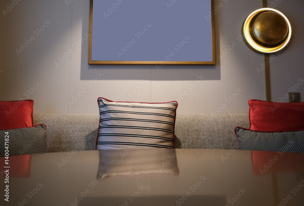 Luxurious mini suite stateroom cabin room onboard luxury cruise ship cruiseship ocean liner with bedroom and living area in red and creme with wood in modern Art Deco interior design