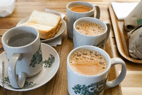 Popular drink in Malaysia called Teh Tarik. It is a sweet drink made from tea with milk. Fractal on the cup is generic print.