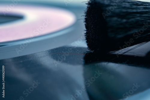 Soft brush gently removing dust and debris from vinyl record surface, ensuring optimal playback and preserving audio fidelity