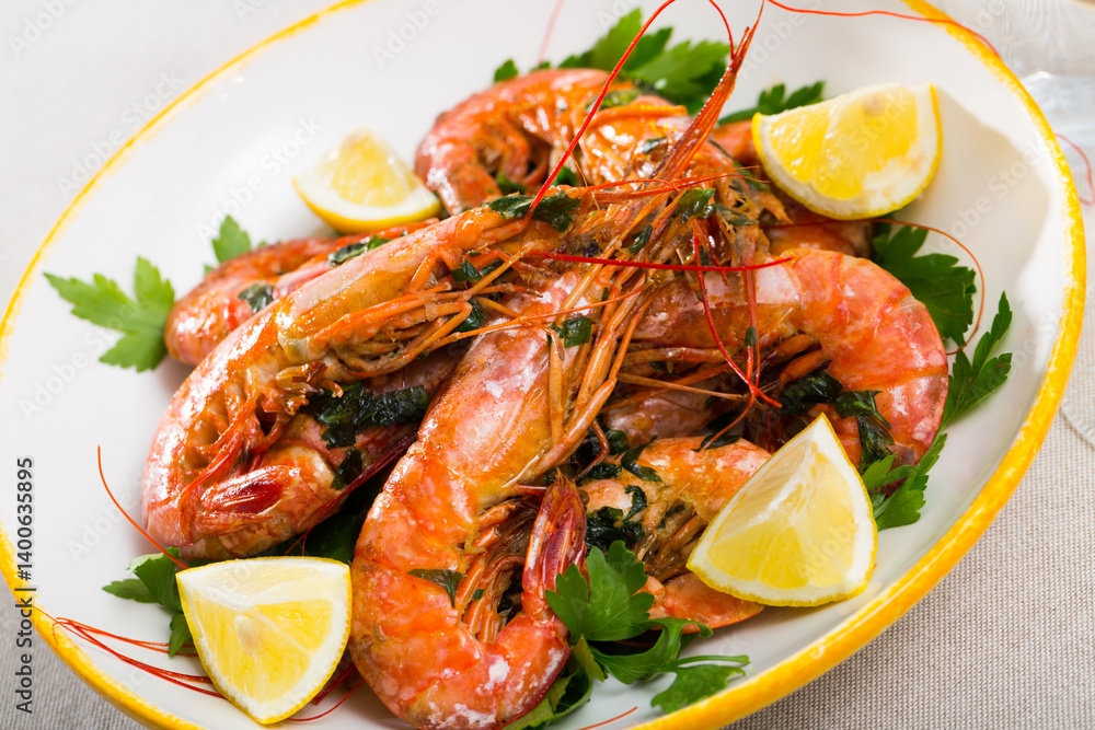 Appetizing grilled shrimps served with parsley and lemon on white plate.. Appetizing grilled shrimps served with parsley and lemon on white plate..