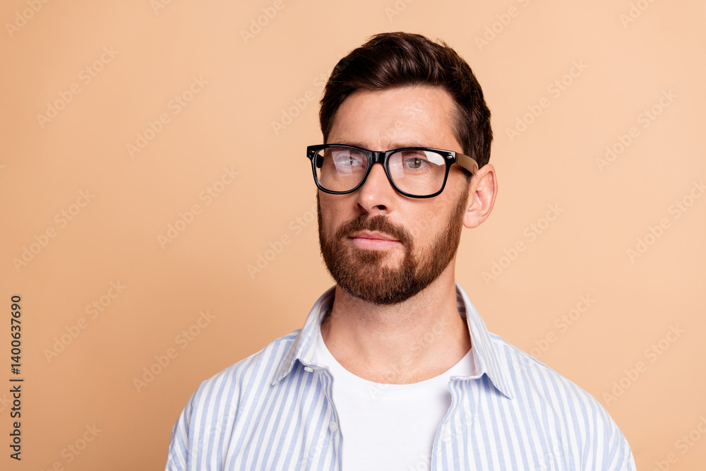 Portrait of a Stylish Bearded Man in a Casual Striped Shirt with Glasses on a Neutral Background Portrait of a Stylish Bearded Man in a Casual Striped Shirt with Glasses on a Neutral Background