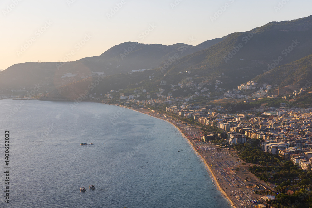 Scenic overlook of a coastal town surrounded by forested mountains