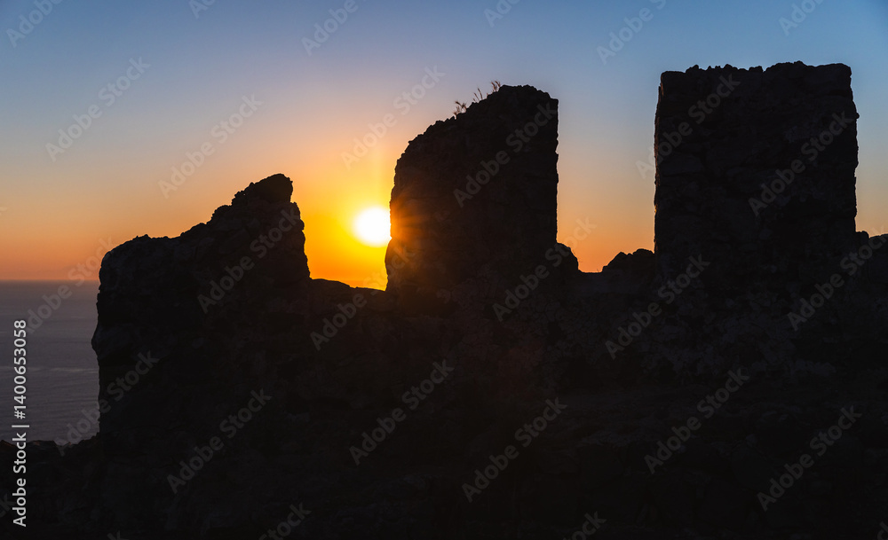 Black silhouette of Alanya Kale wall at sunset, Turkey