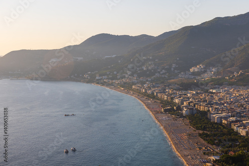 Scenic overlook of a coastal town surrounded by forested mountains