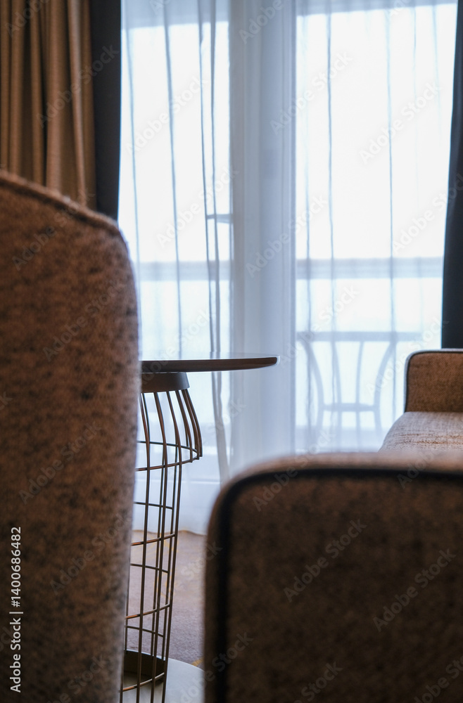 Luxurious mini suite stateroom cabin room onboard luxury cruise ship cruiseship ocean liner with bedroom and living area in red and creme with wood in modern Art Deco interior design