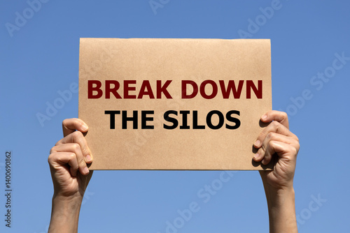 Foto Break down the silos on brown paper holding by 2 hands of a man