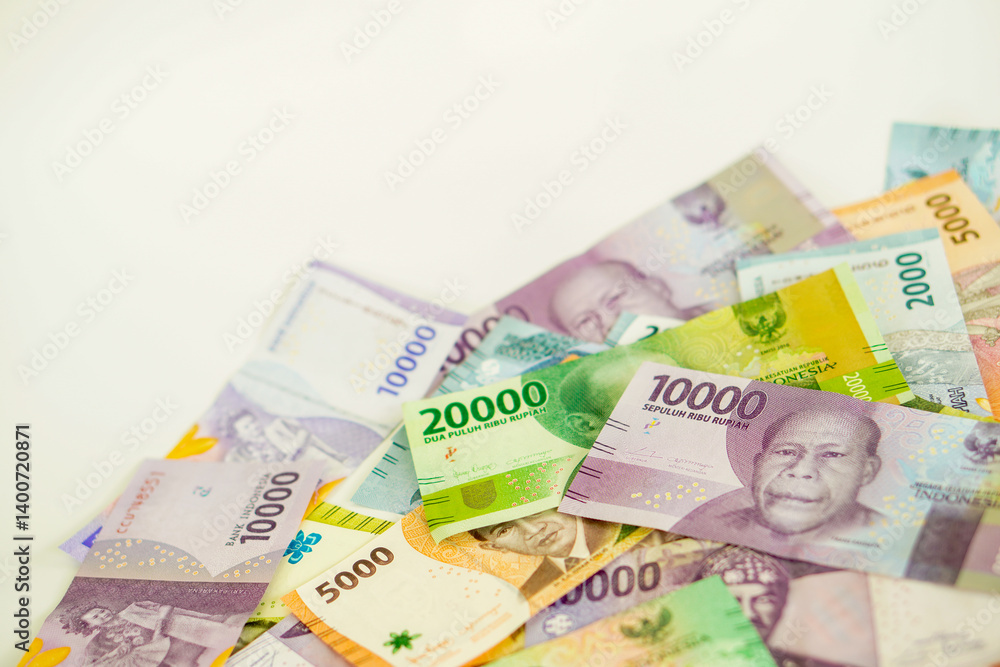 Obraz premium stack of various Indonesian banknotes with negative space, from one thousand rupiah to twenty thousand rupiah. Suitable for background, finance, banking, cash, savings.