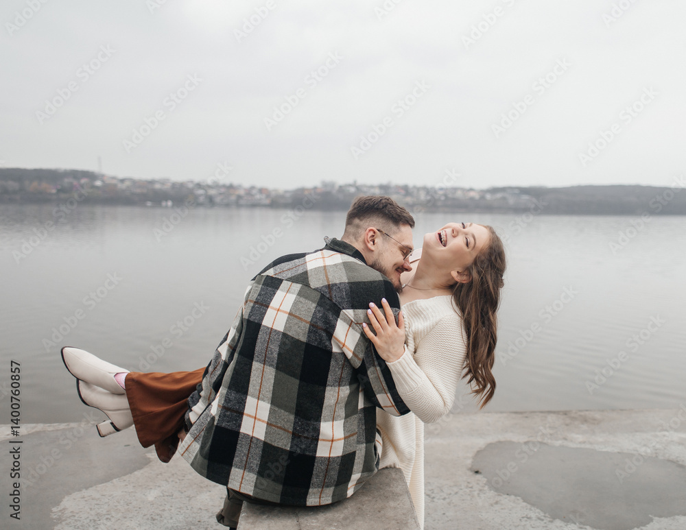 Fototapeta premium Smile with braces. Beautiful girl with braces on a date. Young people dancing, kissing and hugging, enjoying the meeting
