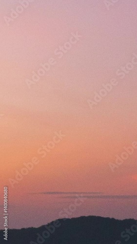 time lapse reveals the dynamic play of light and shadow, showcasing a canvas of clouds against the vibrant hues of sunrise. Climate concept.Vertical copy space