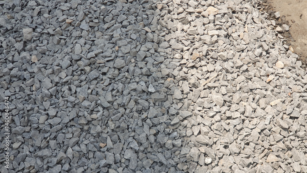 Gray and light gray crushed stone aggregate a construction material photographed outdoors in bright Gray and light gray crushed stone aggregate a construction material photographed outdoors in bright