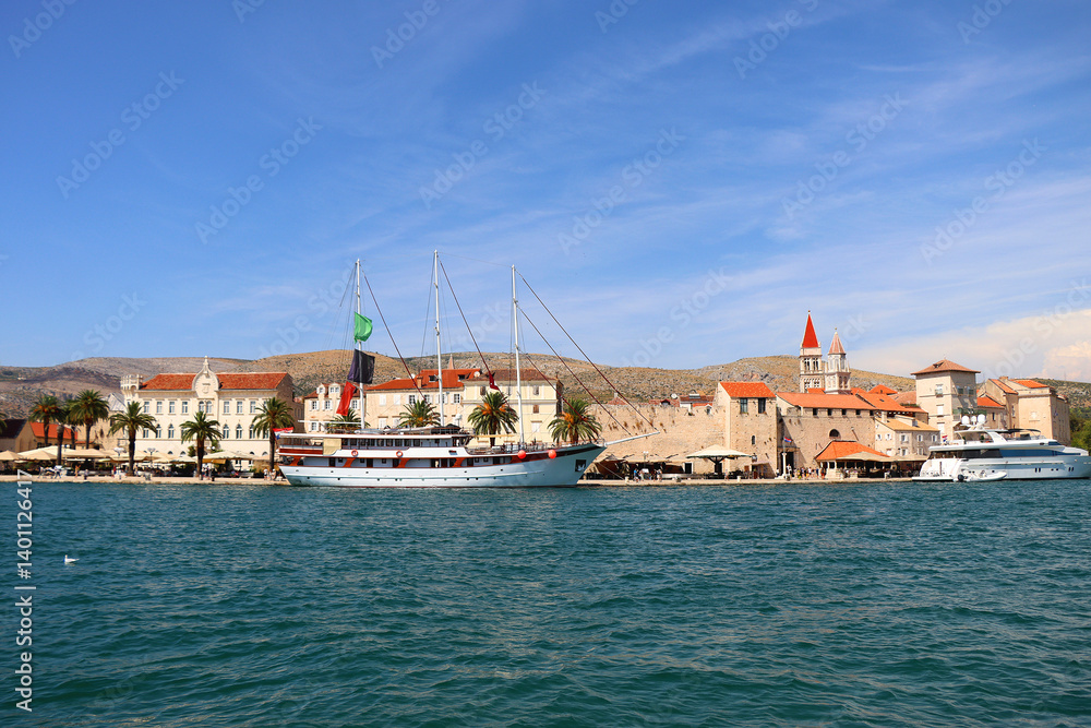 Beautiful old buildings, boats and yachts on the promenade in Trogir, Croatia. Sunny summer day in Trogir.