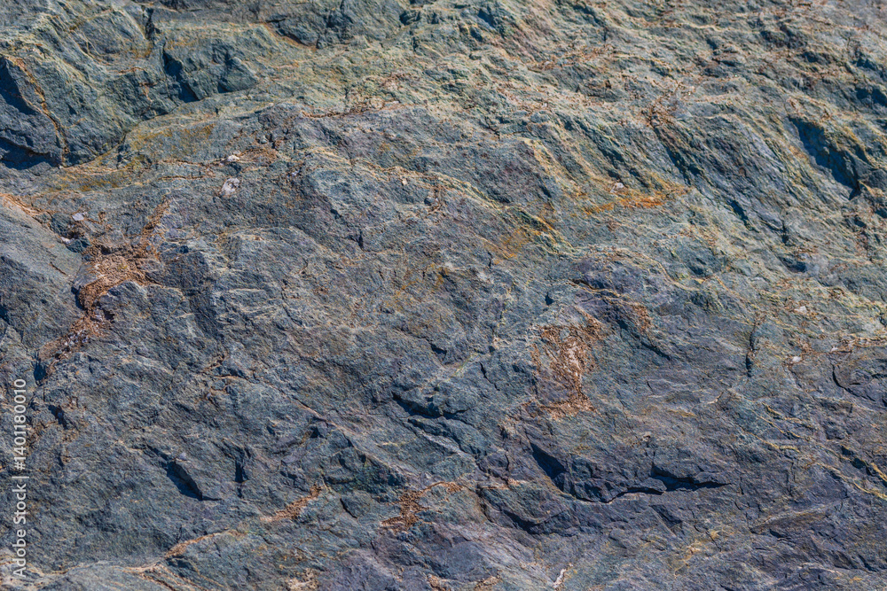 Obraz premium Wavy foliated metamorphic rock, irregular texture, natural surface, outdoor, daylight