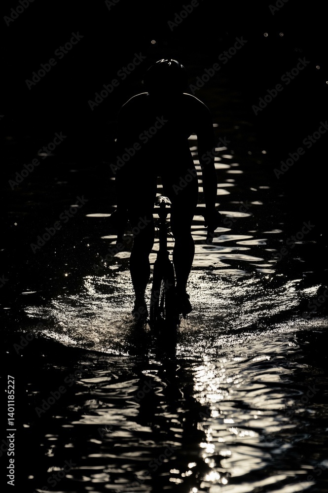 Dark silhouette of a cyclist