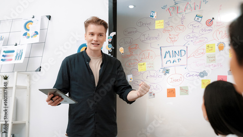 Obraz na płótnie Professional male leader presents start up project by using mind map, colorful sticky notes and business statistic graph with confident while investor listening carefully. Immaculate. w salonie
