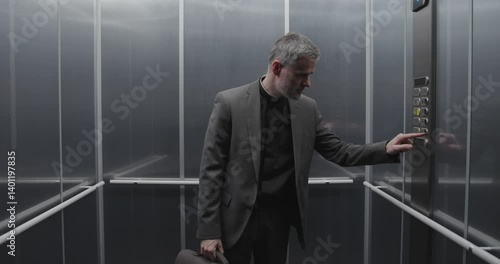 A priest gets stuck in a broken elevator, he raises his hands and starts praying