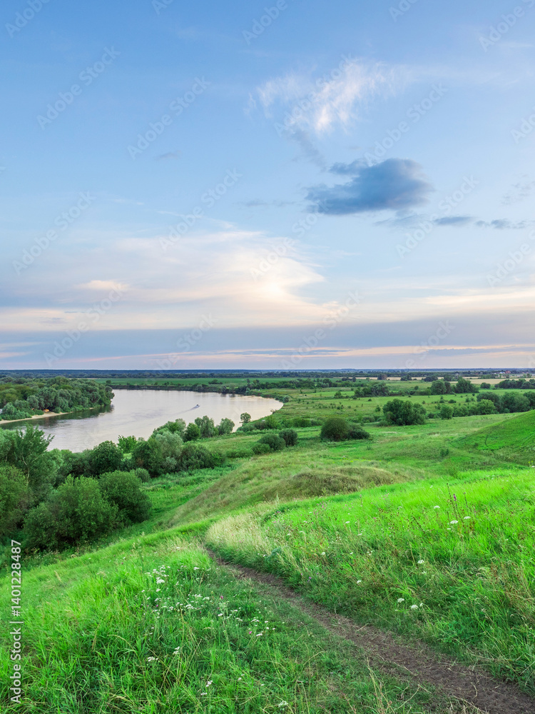 Beautiful green field with a river running through it Beautiful green field with a river running through it