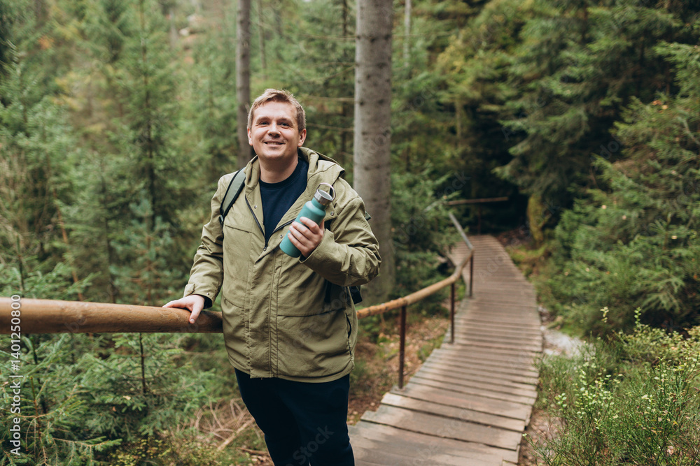Young man hiking in nature. Travel, adventure. Concept of an active lifestyle. The National park Adrspach Teplice rocks. High quality photo.