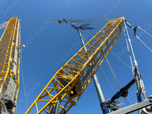 Construction cranes. View from below. Crane used to construct palaces, houses or buildings. Construction site. General contest
