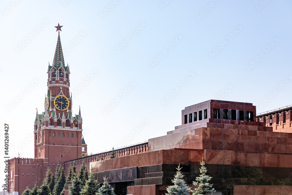 Spasskaya Tower of Moscow Kremlin against background of blue sky. Famous chimes are the main clock of Russia. Sights of Russia, a historical building, symbol of the country. Spasskaya Tower of Moscow Kremlin against background of blue sky. Famous chimes are the main clock of Russia. Sights of Russia, a historical building, symbol of the country.