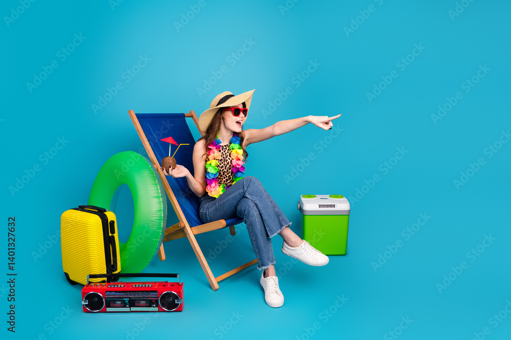 Smiling young woman in casual style enjoying summer vacation with travel essentials and pointing towards horizon