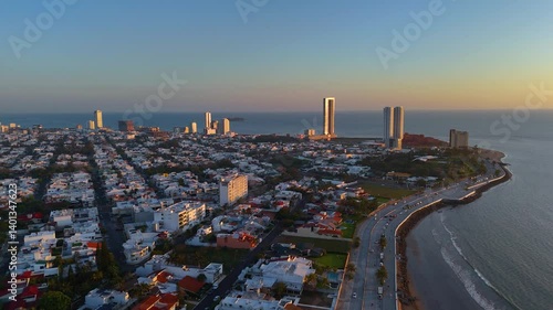 Aerial video flying over Veracruz, Mexico in the municipality of Boca del Rio at sunrise. The city looks huge and imposing